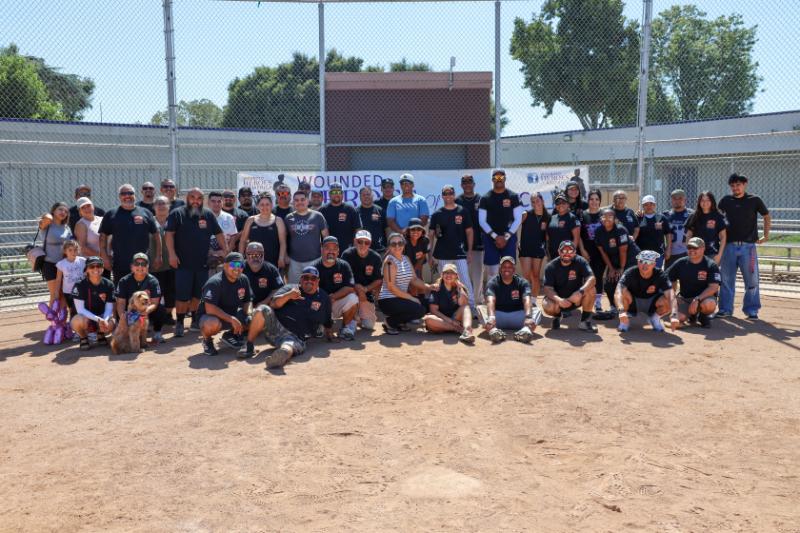 Posed photo with softball players and guests Posed photo with softball players and guests